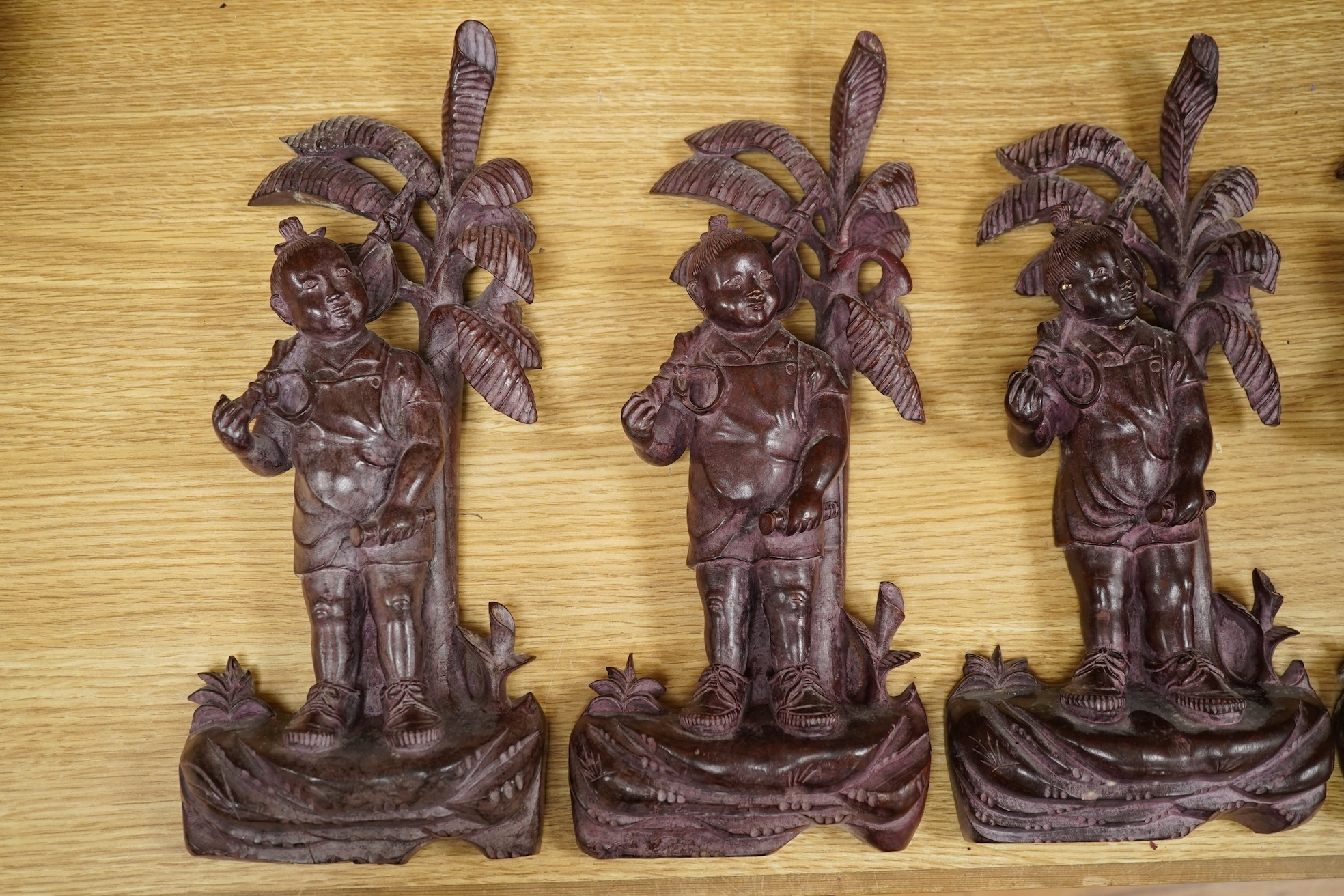 Four 1960's Chinese Cultural Revolution figures of boys holding a rifle, 33cm high